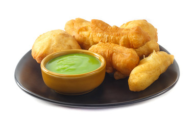 Dish of deep-fried doughstick on white background