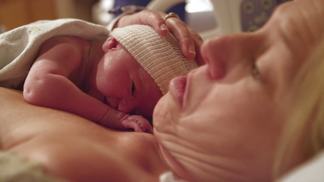A happy mother with her newborn baby that was born minutes before