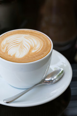 hot coffee latte, latte art with heart in a white cup