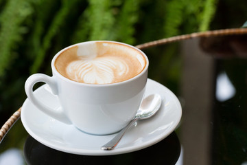 hot coffee latte, latte art with heart in a white cup