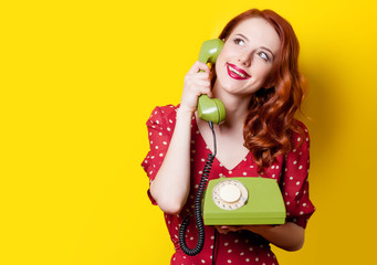 girl in red dress with green dial phone