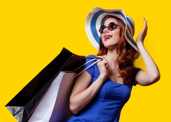 girl in blue dress with shopping bags