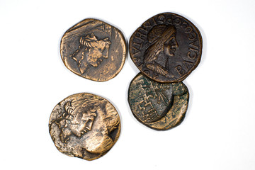 Vintage bronze coins with portraits on a white background