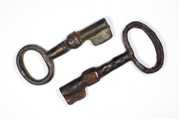 Two old keys to the safe on a white background