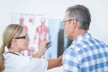 Doctor showing X rays to her patient 