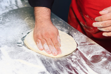 Italian chef preparing pizza dough