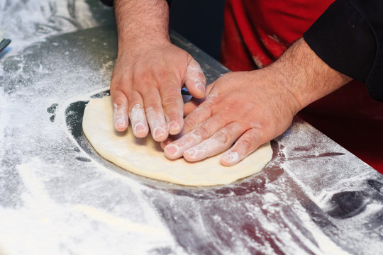 Italian chef preparing pizza dough