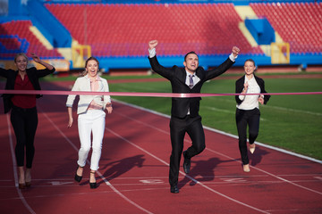 business people running on racing track