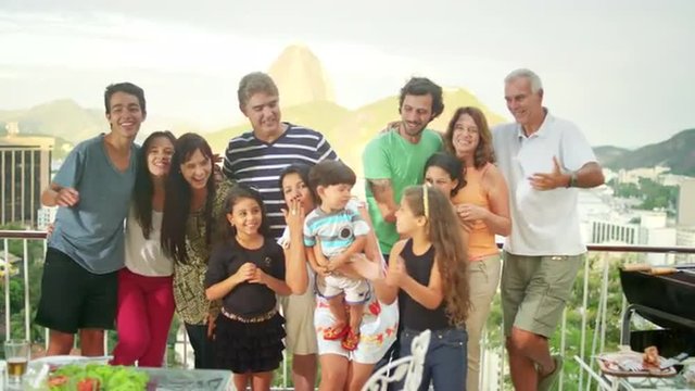 Family posing for a portrait at a Brazilian family BBQ