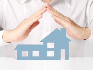 holding house representing home ownership