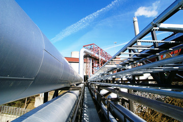 Industrial zone, Steel pipelines and valves against blue sky