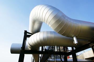Industrial zone, Steel pipelines and valves against blue sky