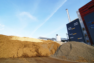 bio power plant with storage of wooden fuel (biomass) against bl