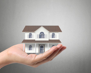 holding house representing home ownership