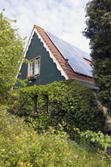Fototapeta na wymiar traditional dutch house with wooden front and solar panels