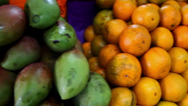 A pile of freshly picked fruit sit in a pile at a Mexican market