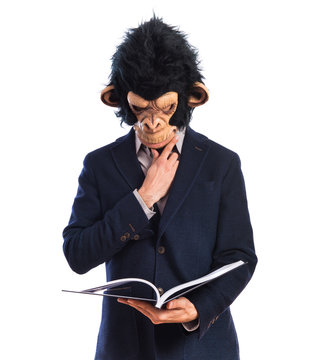 Monkey man reading book