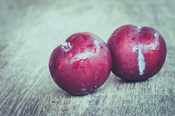 plums on wood background with filter effect retro vintage style