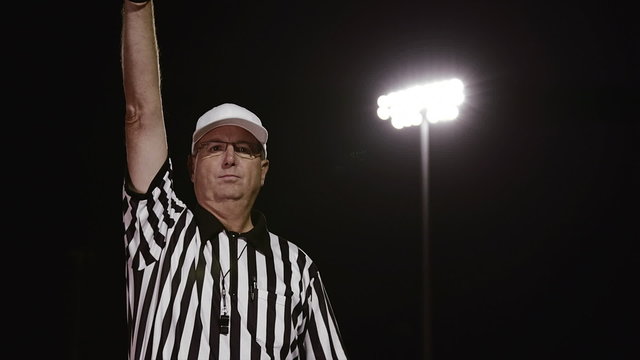 A Football Referee Makes A False Start Penalty Hand Signal 