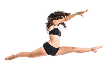 Young ballet dancer jumping over white background