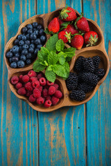 Farm fresh summer berries in wooden tray