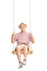 Playful senior swinging on a swing