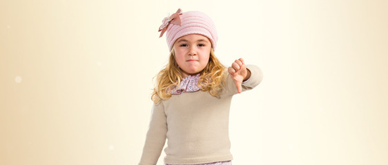 Little girl doing a bad signal