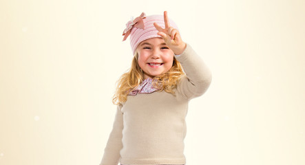 Little girl doing victory gesture