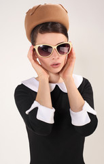 beautiful brunette woman in a retro style with sunglasses