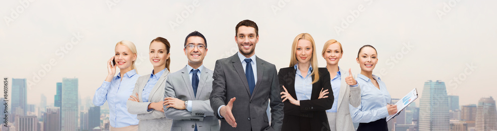 Wall mural group of smiling businessmen making handshake