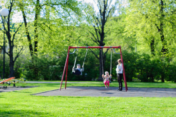 Blurred summer scene in park with people
