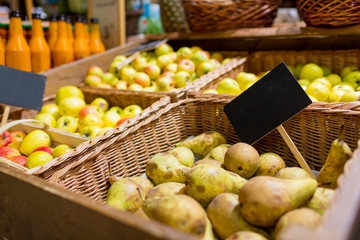 fruits in baskets with nameplates at food market