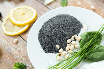 close up of peeled peanuts, greens and chia seeds