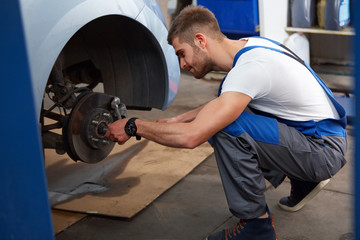 Portrait of a Mechanic Servicing a Car at His Workshop