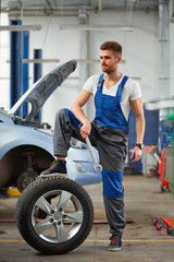 Obraz na płótnie Canvas Auto repair service. Handsome young mechanic.