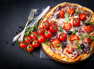 Pizza with cherry tomatoes and arugula