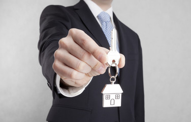 House key in businessman hand with clipping path