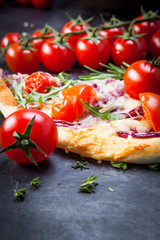 Pizza with cherry tomatoes and arugula