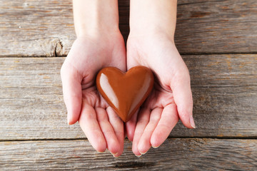 Woman's hands with chocolate heart
