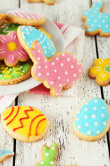 Colorful easter cookies on white wooden background