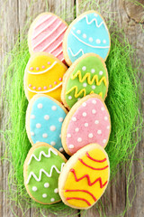 Colorful easter cookies on grey wooden background