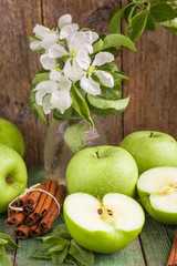 Green apples, mint and cinnamon on the table