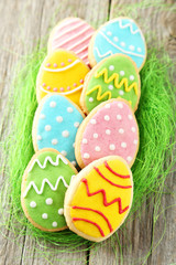 Colorful easter cookies on grey wooden background