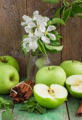 Green apples, mint and cinnamon on the table