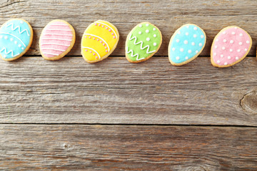 Colorful easter cookies on grey wooden background