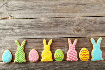 Colorful easter cookies on grey wooden background