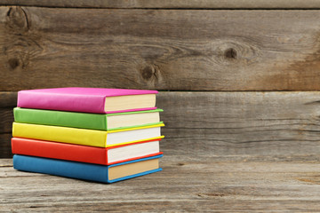 Open books on grey wooden background