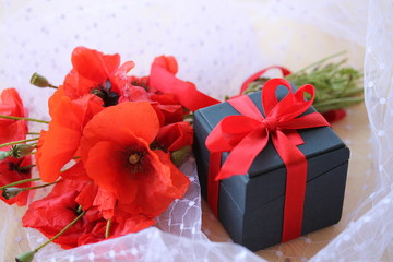 romantic bouquet of poppies and a gift