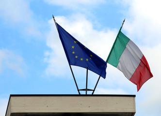 italian flag and European flag in the blue sky