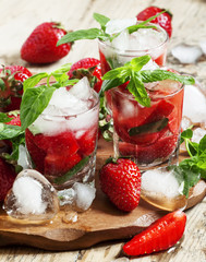 Strawberry cocktail with mint and ice, selective focus
